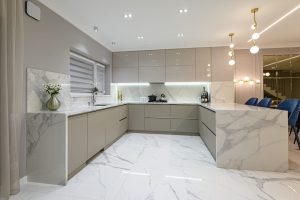 Luxury large modern white marble kitchen united with dining room and living room